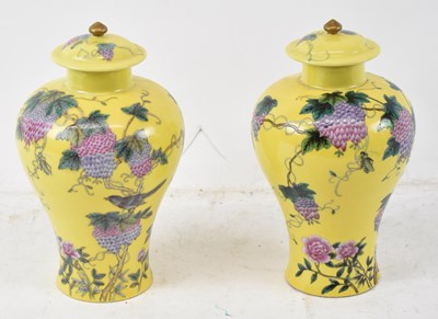 Lot 615 - A pair of Chinese porcelain jars with covers,...