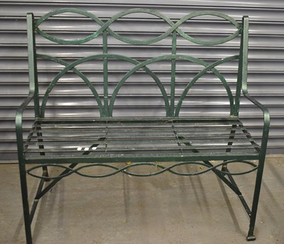 Lot 153 - A green painted wrought iron garden bench,...