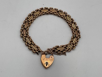 Lot 411 - A 9ct yellow gold bracelet with padlock clasp,...