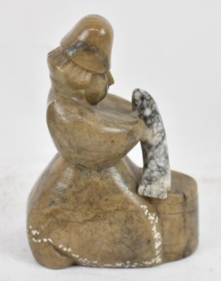 Lot 413 - A carved stone figure straddling a barrel and...