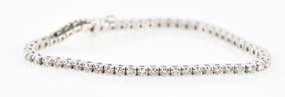 Lot 494 - A 14ct white gold and diamond tennis bracelet...