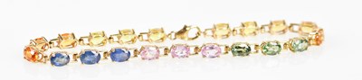 Lot 555 - A 9ct yellow gold and multicoloured synthetic...