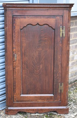 Lot 102 - A 19th century oak wall hanging corner cupboard.