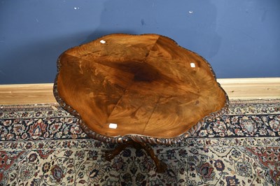 Lot 12 - A 19th century mahogany carved tripod table,...