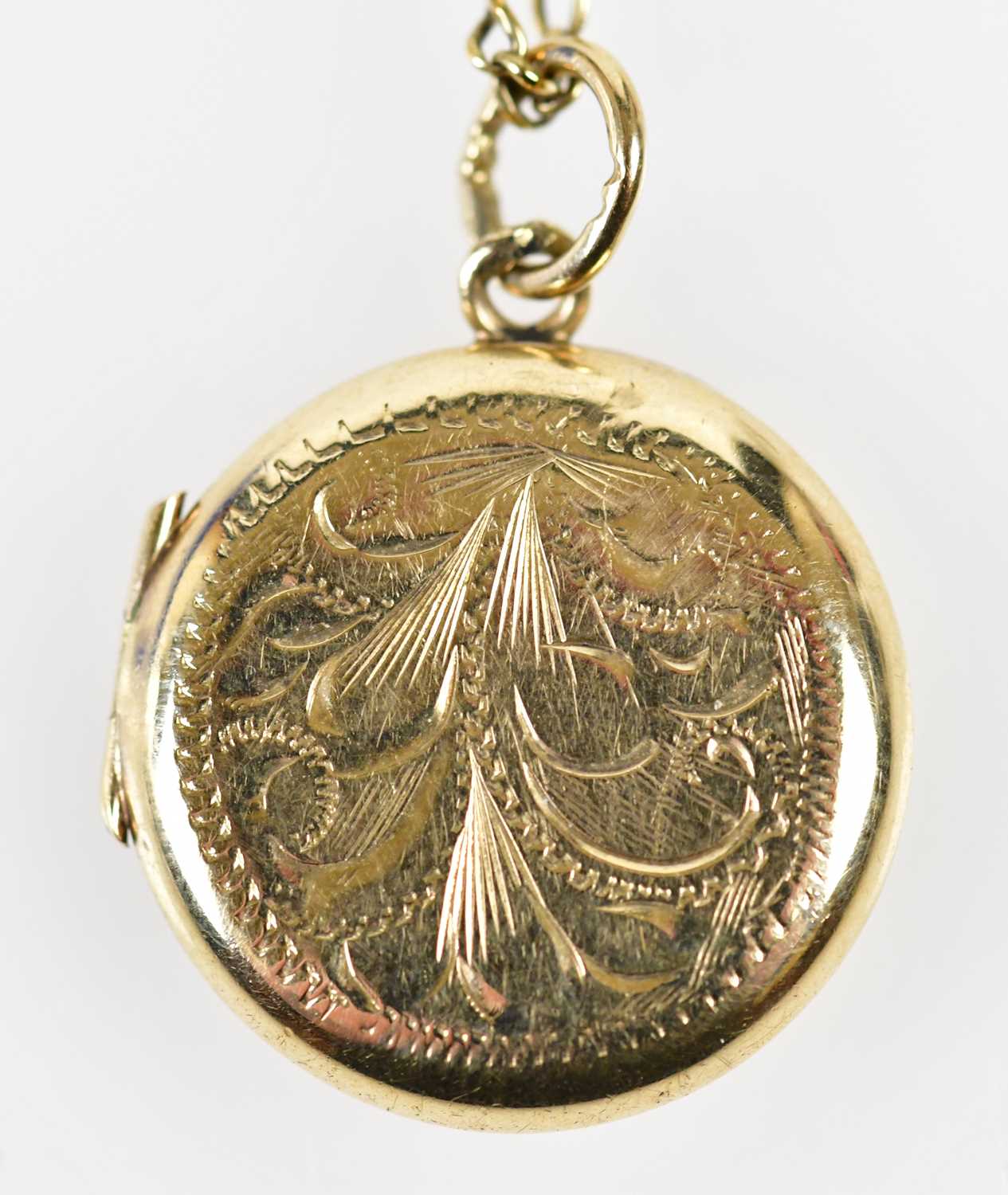 Click H Locket Lot 448 - A 9ct yellow gold engraved circular locket