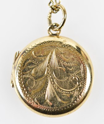 Lot 448 - A 9ct yellow gold engraved circular locket on...