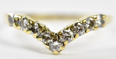 Lot 153 - An 18ct yellow gold and diamond wishbone ring,...