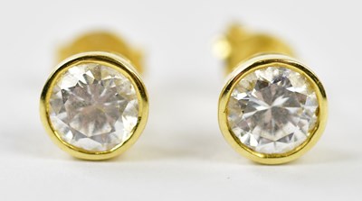 Lot 655 - A pair of 18ct yellow gold diamond collet set...