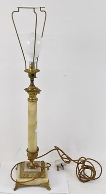 Lot 135 - An onyx and gilt metal mounted table lamp,...