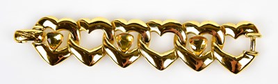 Lot 828 - YVES SAINT LAURENT; a gold tone metal heart...