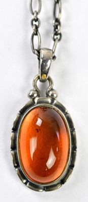 Lot 408 - GEORG JENSEN; a silver and amber pendant...