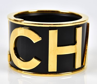 Lot 813 - CHANEL; a broad flat sectioned bangle, circa...