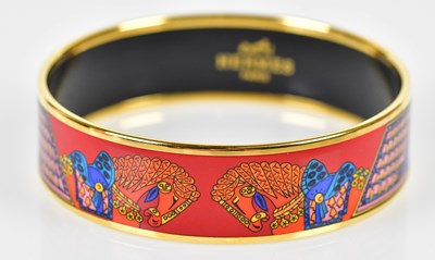 Lot 829 - HERMÈS; an enamel painted bangle with gold...