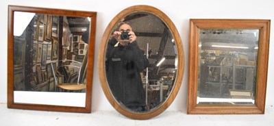 Lot 84 - An oak framed oval wall mirror, another oak...