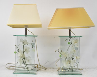 Lot 148 - A pair of modern glass lamps containing...