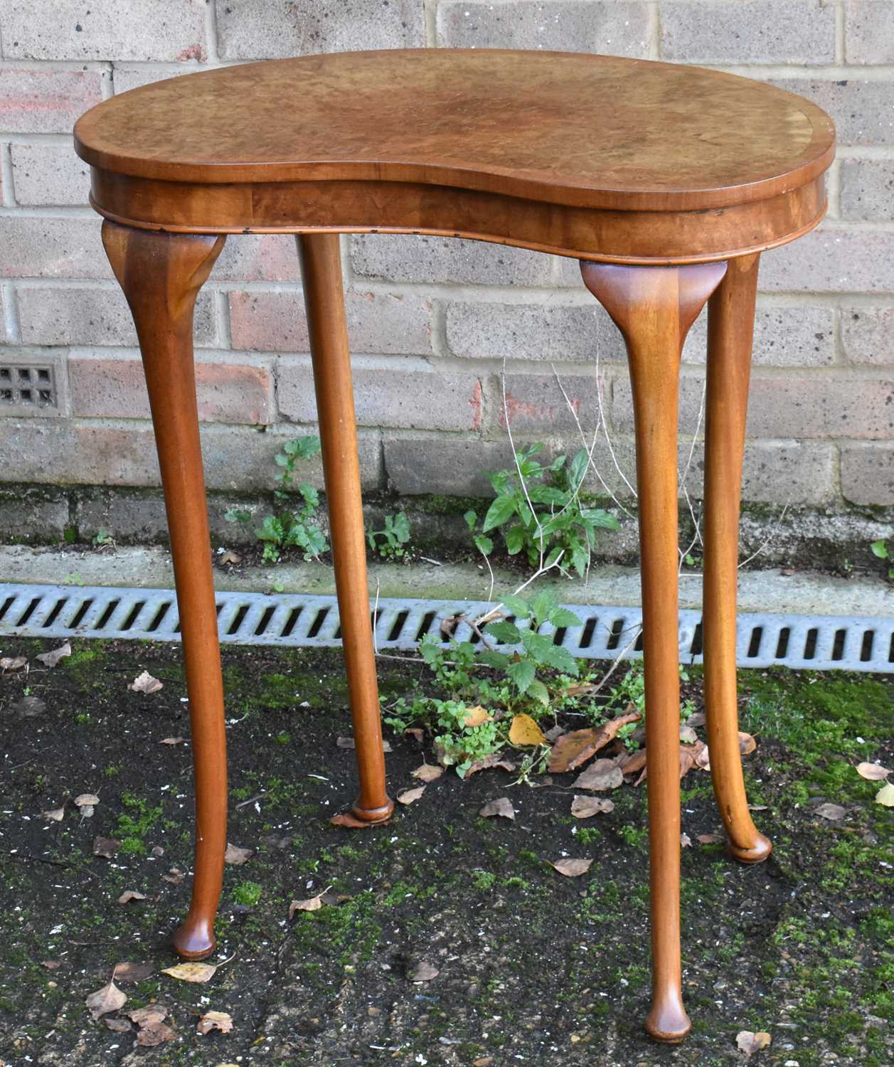 Lot 74 A walnut kidney shaped side table, width 60cm.