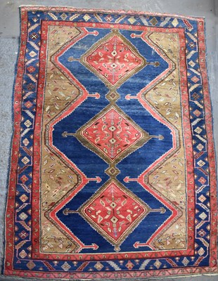 Lot 119 - A large Persian red and blue ground rug with...