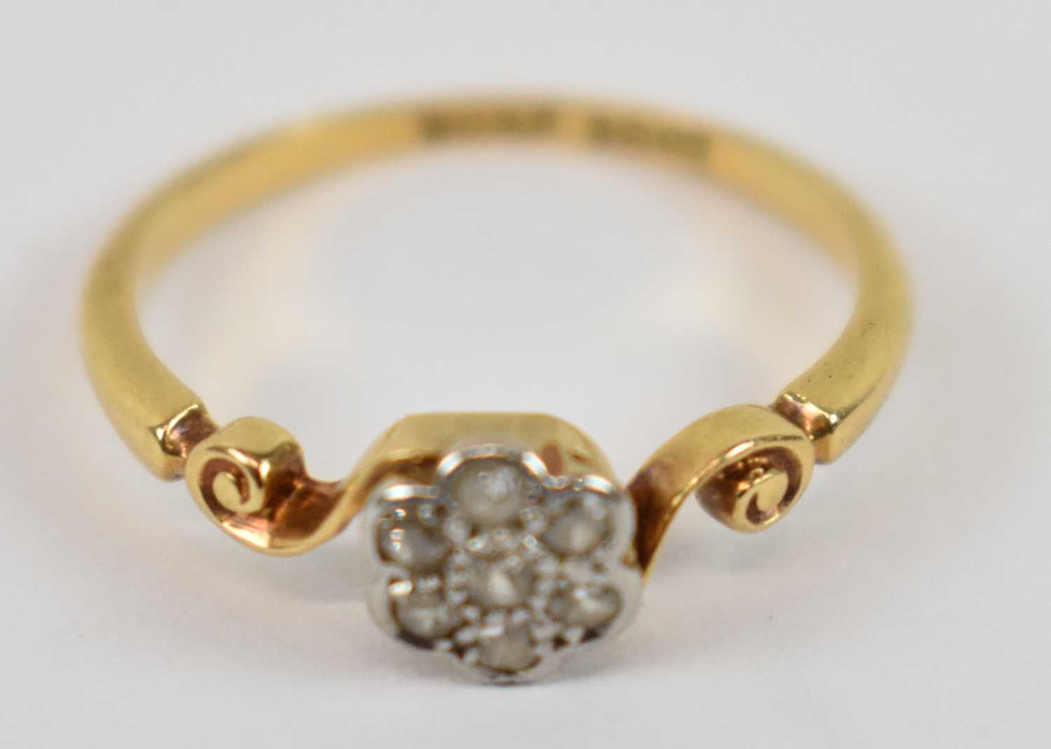 Lot 797 - An 18ct yellow gold flower head ring set with...