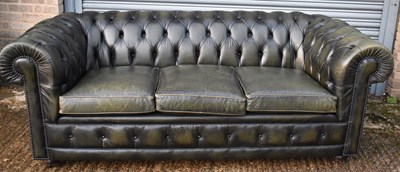 Lot 17 - A green leather button upholstered three...