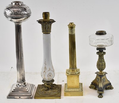 Lot 137 - A group of four oil lamps, to include large...