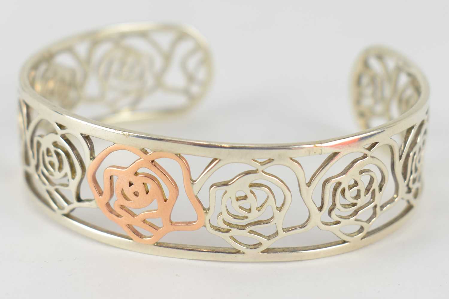 Lot 1073 - CLOGAU; a silver and rose gold 'Royal Roses'...