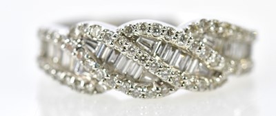 Lot 76 - An 18ct white gold diamond ring set with both...