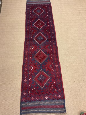 Lot 544 - A Meshwani runner, length 254cm, width 64cm.