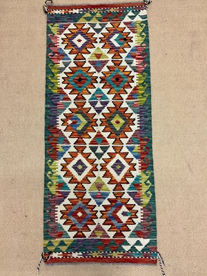 Lot 553 - A Chobi Kilim runner, length 144cm, width 58cm.