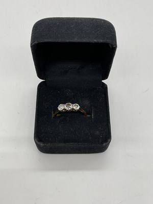 Lot 405 - A yellow metal three stone graduated diamond...