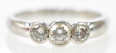 Lot 97 - A platinum and diamond three stone brilliant...