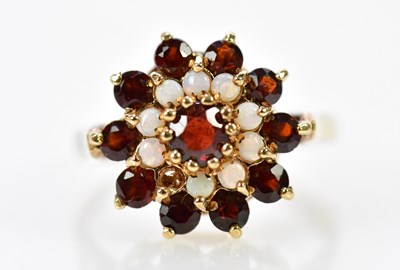 Lot 229 - A 9ct rose gold garnet and opal cluster ring...