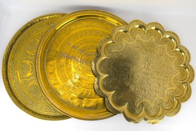 Lot 650 - Three large Indian/Persian brass trays, one...