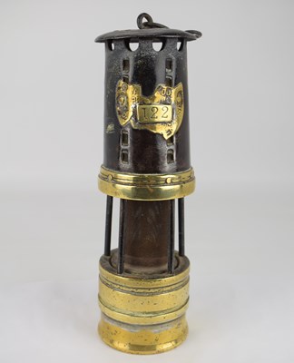 Lot 132 - An early 20th century miners' lamp with wire...
