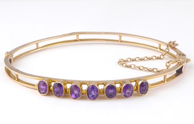 Lot 1065 - A 9ct gold amethyst hinged bracelet with seven...