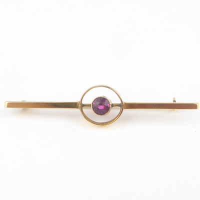 Lot 1077 - A 9ct gold bar brooch with bezel set cut red...