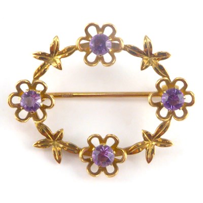 Lot 1078 - A 9ct gold oval open floral brooch, four...