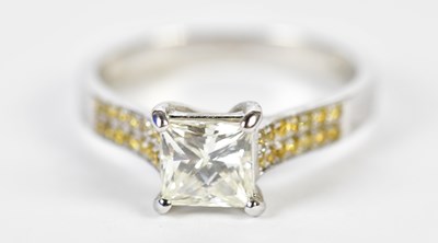 Lot 54 - An 18ct white gold solitaire ring, the four...