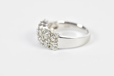 Lot 48 - An 18ct white gold diamond half eternity ring...
