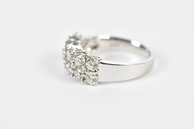 Lot 64 - An 18ct white gold diamond half eternity ring...