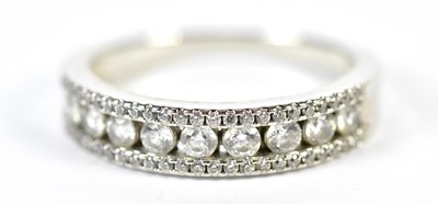 Lot 94 - A white metal diamond half eternity ring with...