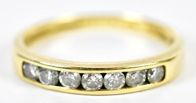 Lot 183 - An 18ct yellow gold and diamond channel set...