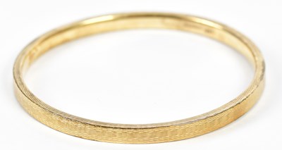 Lot 551 - A 9ct yellow gold bangle, approx. 10.3g,...