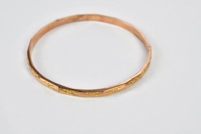 Lot 542 - A 9ct gold bangle, approx. 7.8g, an 18ct gold...