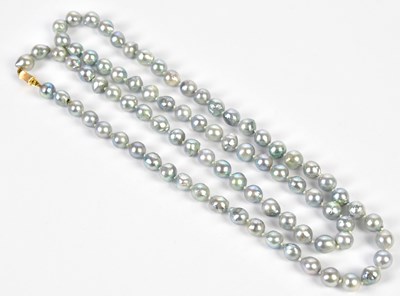 Lot 456 - A hand tied string of grey pearls with yellow...