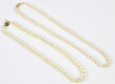 Lot 722 - Two strings of hand tied pearls, one with 9ct...