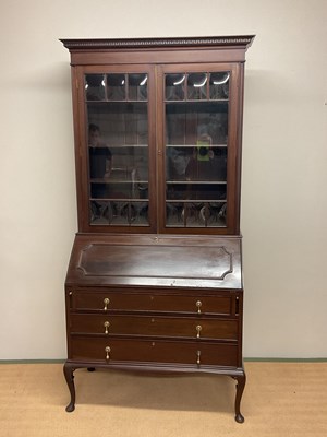 Lot 664 - An Edwardian mahogany bureau bookcase raised...