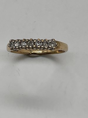 Lot 423 - A 9ct yellow gold half eternity ring set with...