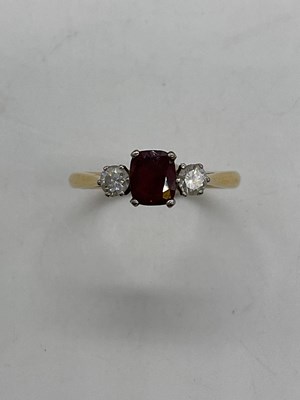 Lot 392 - An 18ct yellow gold ruby and diamond three...