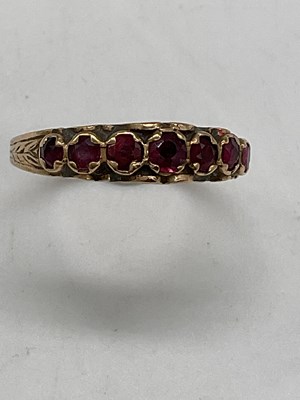 Lot 435 - A 9ct yellow gold seven stone ruby set dress...