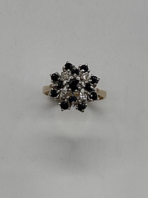 Lot 406 - A 9ct yellow gold sapphire and diamond stepped...